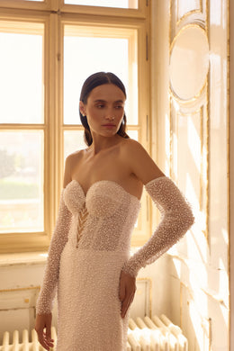 Strapless sweetheart wedding dress with sparkling beadwork and long beaded off-shoulder sleeves