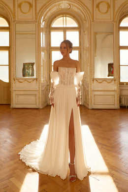 Ivory wedding dress with an embellished lace corset, off-shoulder sleeves, front slit, and sweeping train