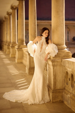 Ivory mermaid wedding dress featuring a high lace neckline, tulle puff sleeves, and a long train