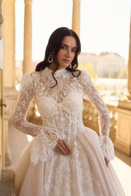 Detailed ivory wedding dress bodice with a high lace neckline, long sleeves, and floral lace embellishment