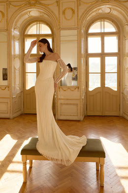 Ivory beaded mermaid wedding dress with sheer off-the-shoulder sleeves and a sweeping train