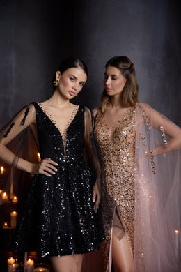 Close-up of a rose-gold sequined evening dress with a plunging V-neckline, thigh-high slit, and sheer train