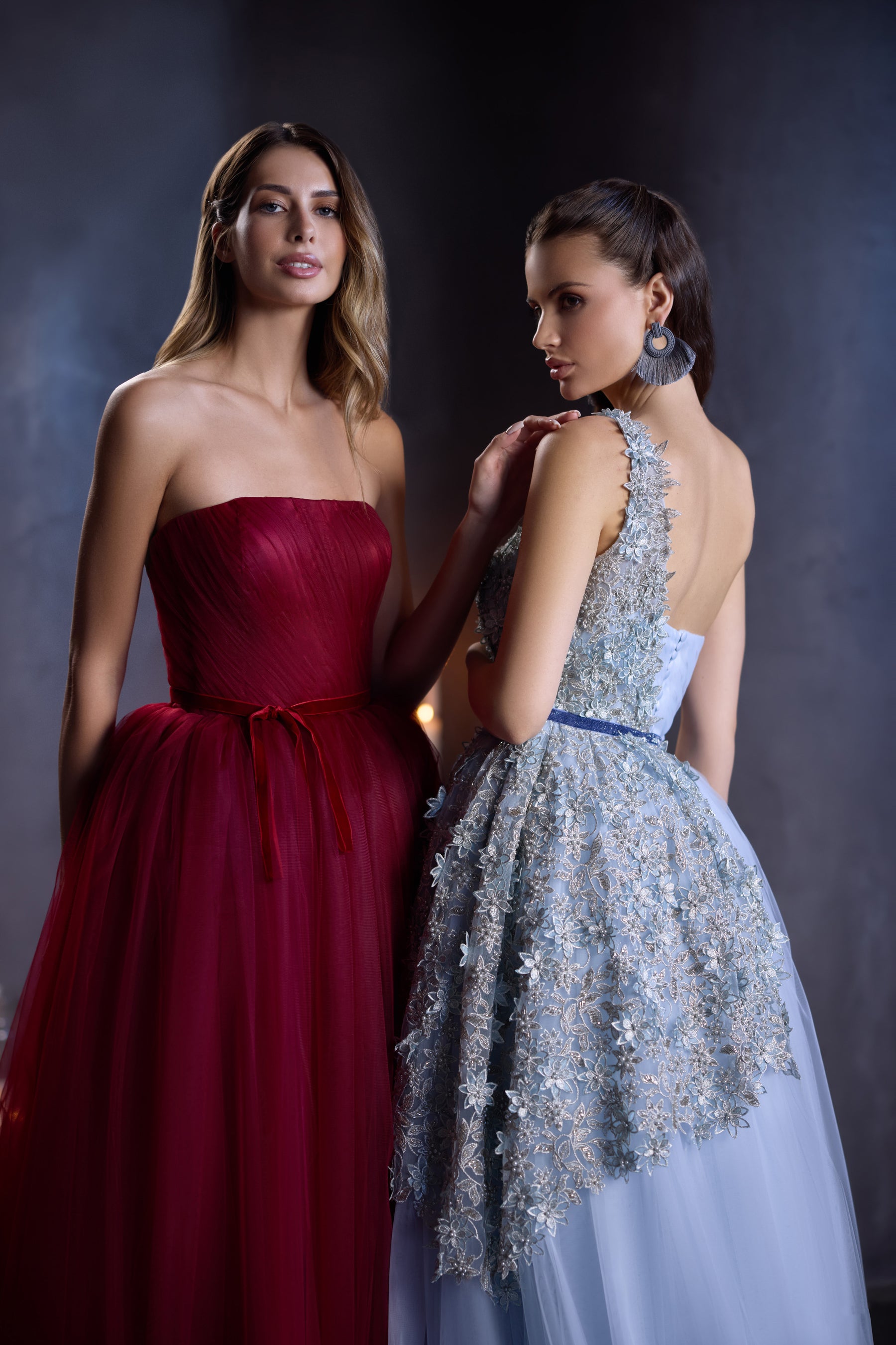 Close-up of a burgundy evening dress with a strapless neckline, gathered waist, and voluminous tulle skirt