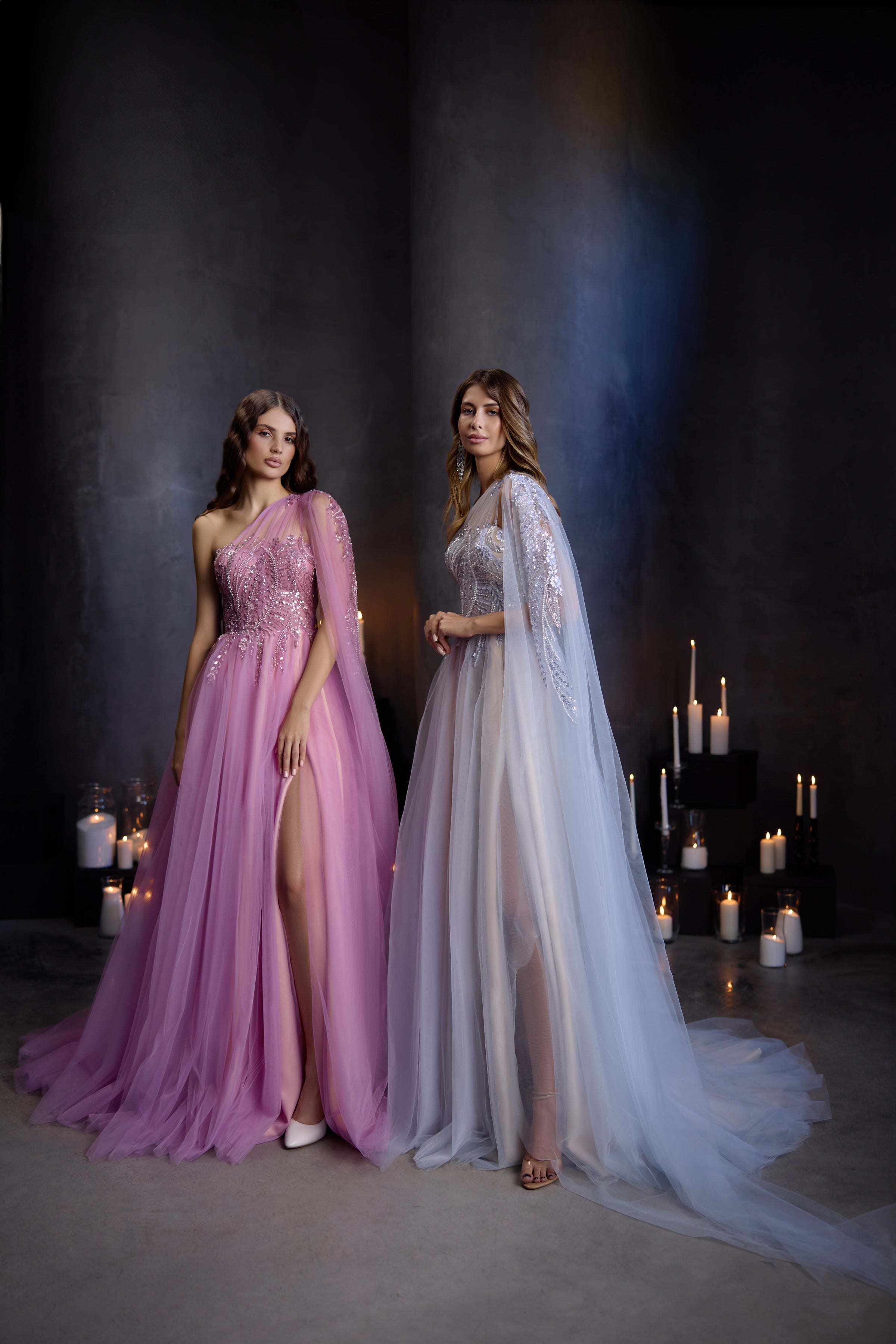Pink beaded one-shoulder evening dress with a flowing A-line skirt and high slit, beside a pale blue gown