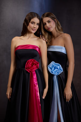 Black strapless evening dresses with red and blue rose appliqués and contrasting full-length panels