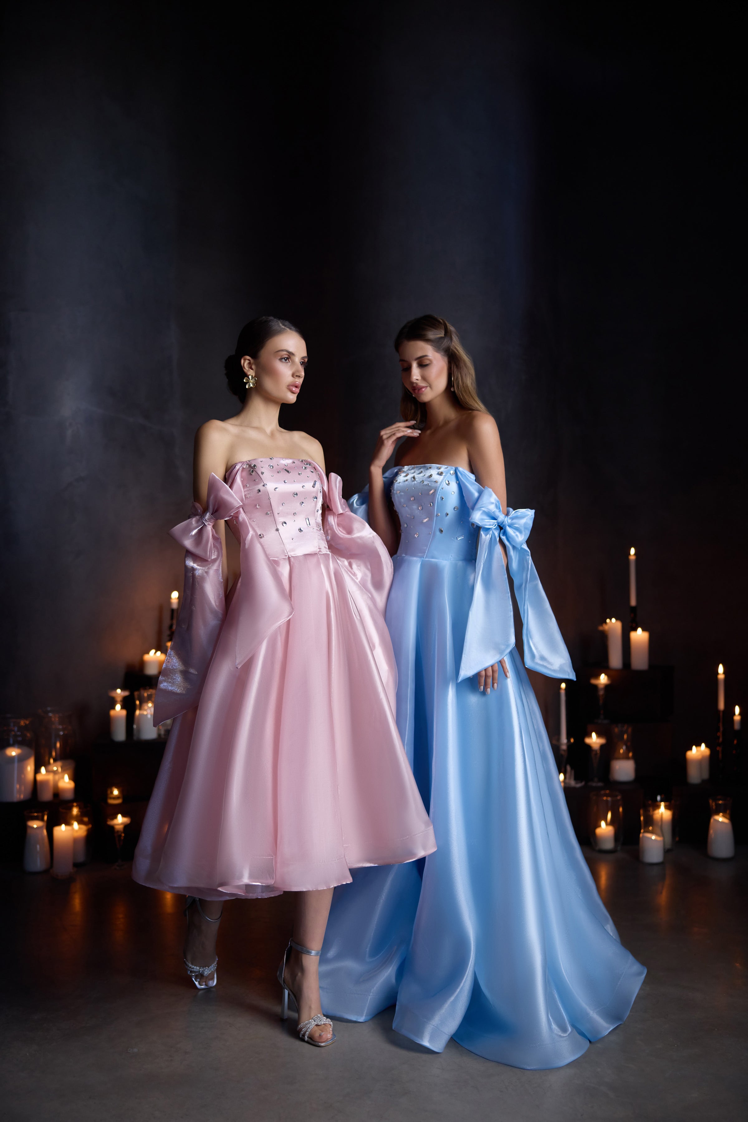 Pink satin evening dress with a strapless embellished bodice, off-shoulder bow drapes, and a full A-line skirt