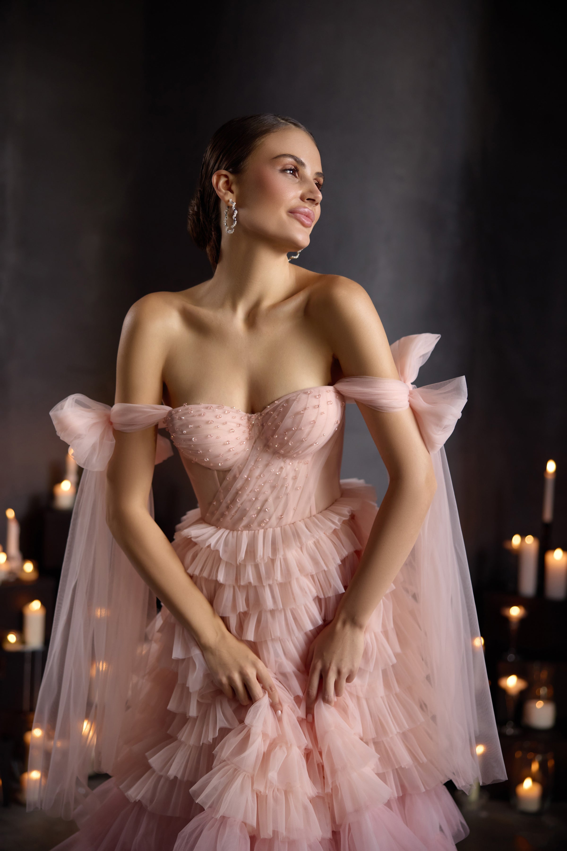 Close-up of a pink evening dress with a dotted tulle sweetheart bodice and sheer off-shoulder sleeves