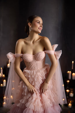 Close-up of a pink evening dress with a dotted tulle sweetheart bodice and sheer off-shoulder sleeves