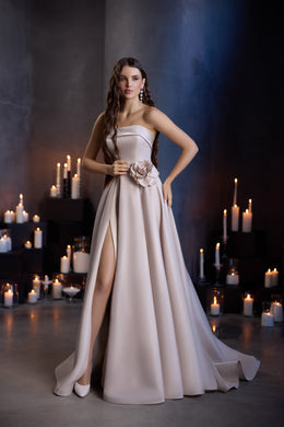 Champagne A-line evening dress with strapless bodice, floral waist applique, thigh-high slit, and sweeping train