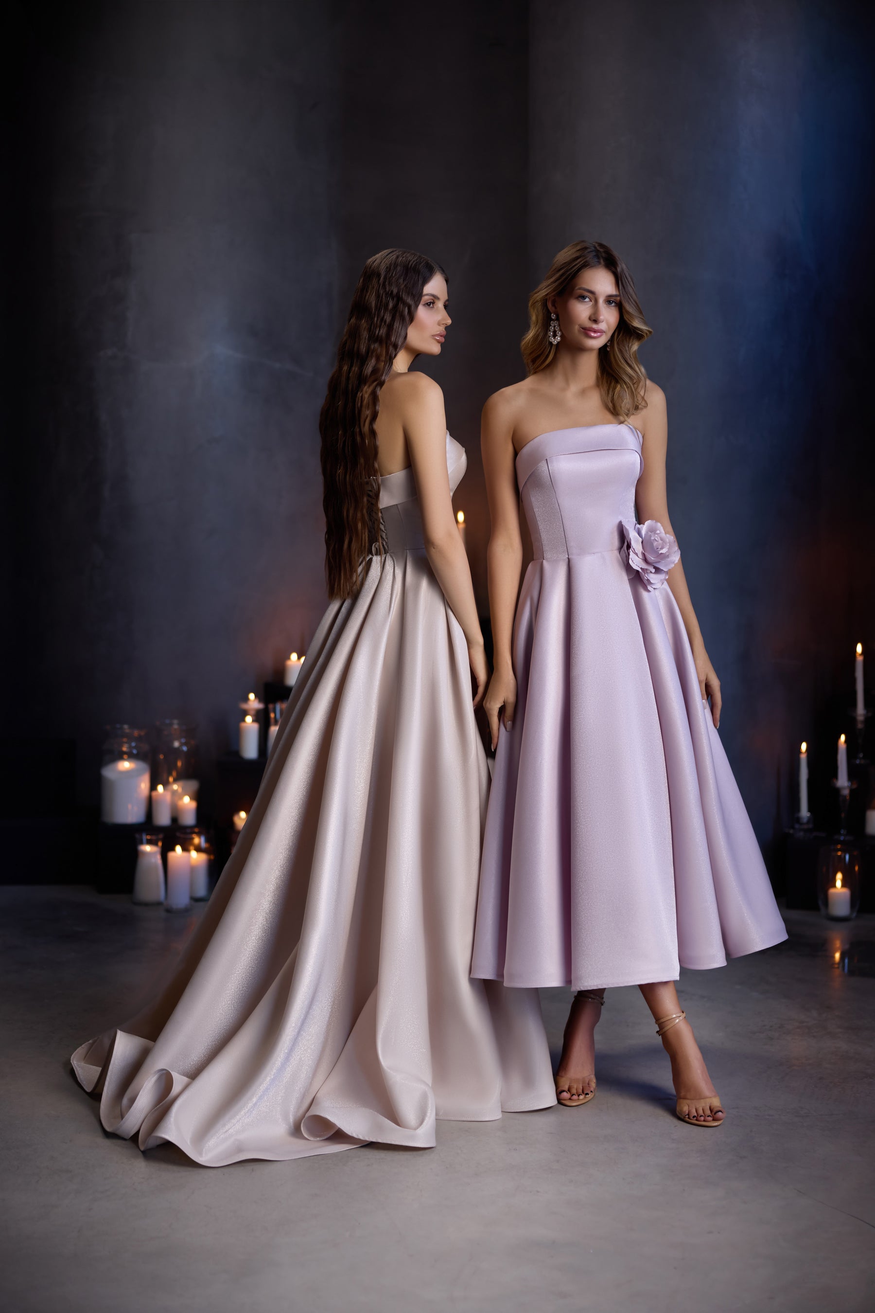 Rear three-quarter view of a champagne evening dress with a flowing A-line skirt and long train