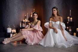 Blush pink evening dress with dramatic bow sleeves, a full A-line skirt, and layered ruffled hem