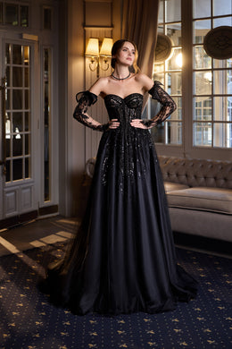Black floor-length evening dress with an off-the-shoulder neckline, sheer lace sleeves, and a full skirt
