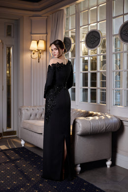 Black evening dress with a fitted silhouette, embellished waist and hip, and a high side slit
