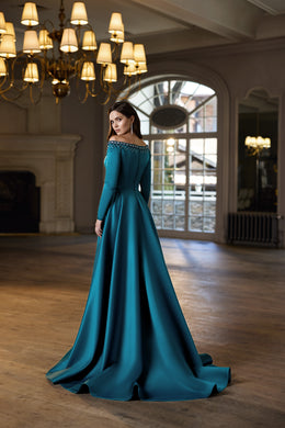 Teal evening dress shown from the back, featuring an embellished neckline, fitted waist, full skirt, and trailing hem