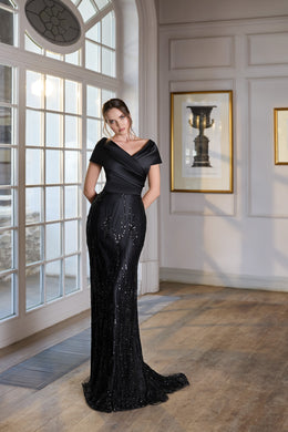 Black sequined evening dress with a draped crossover neckline, short sleeves, fitted silhouette, and sweeping train