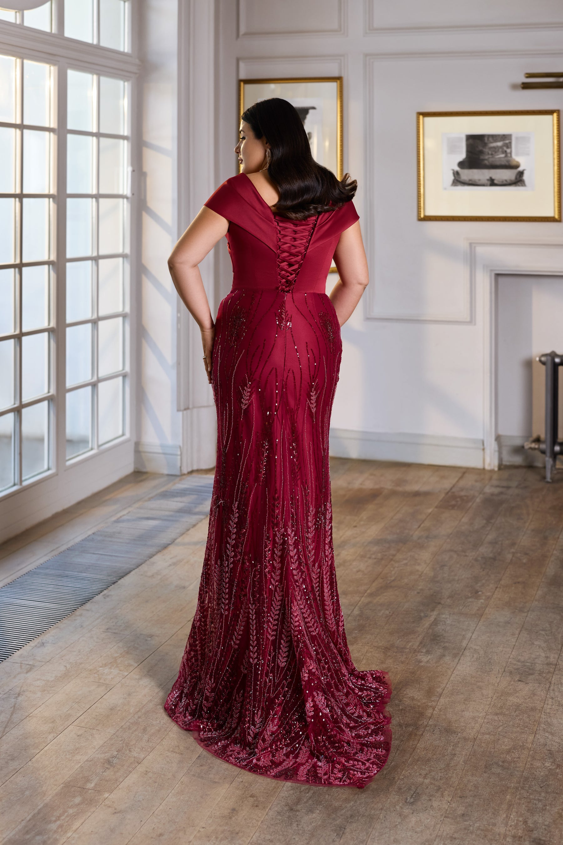 Lace-up back with short sleeves and a sweeping train on a burgundy sequined evening dress