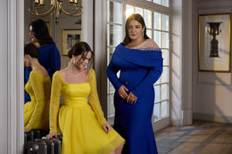 Blue evening dress featuring a beaded sheer neckline, long sleeves, draped off-shoulder collar, and fitted silhouette