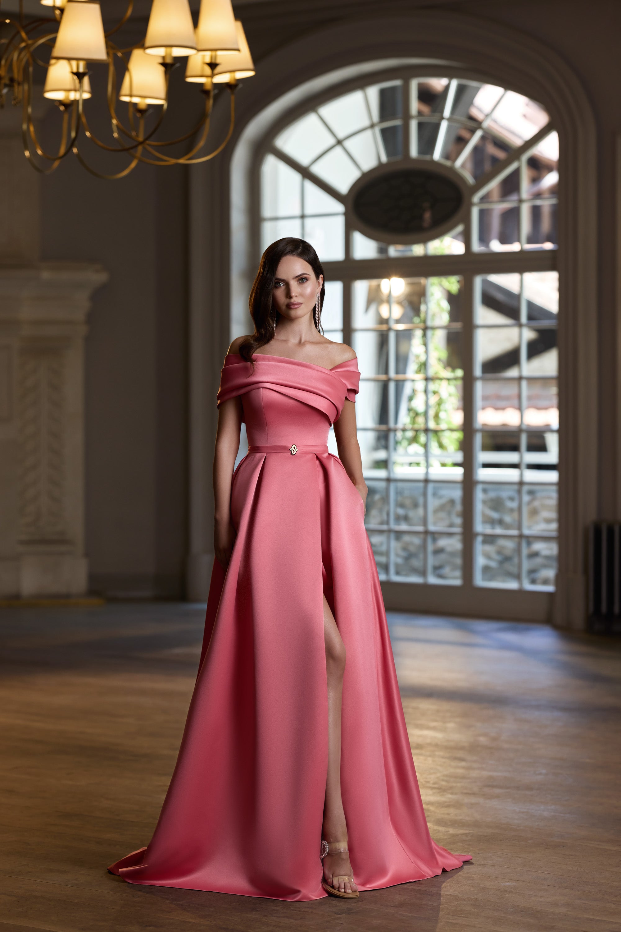 Rose pink evening dress with an off-the-shoulder neckline, fitted waist, and high front slit