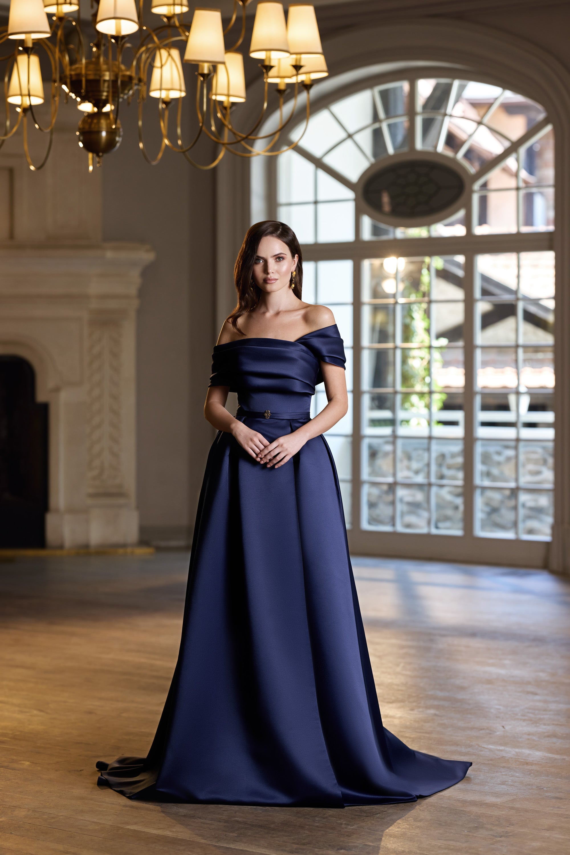 Navy evening dress with an off-the-shoulder neckline, short sleeves, fitted waist, and floor-length skirt
