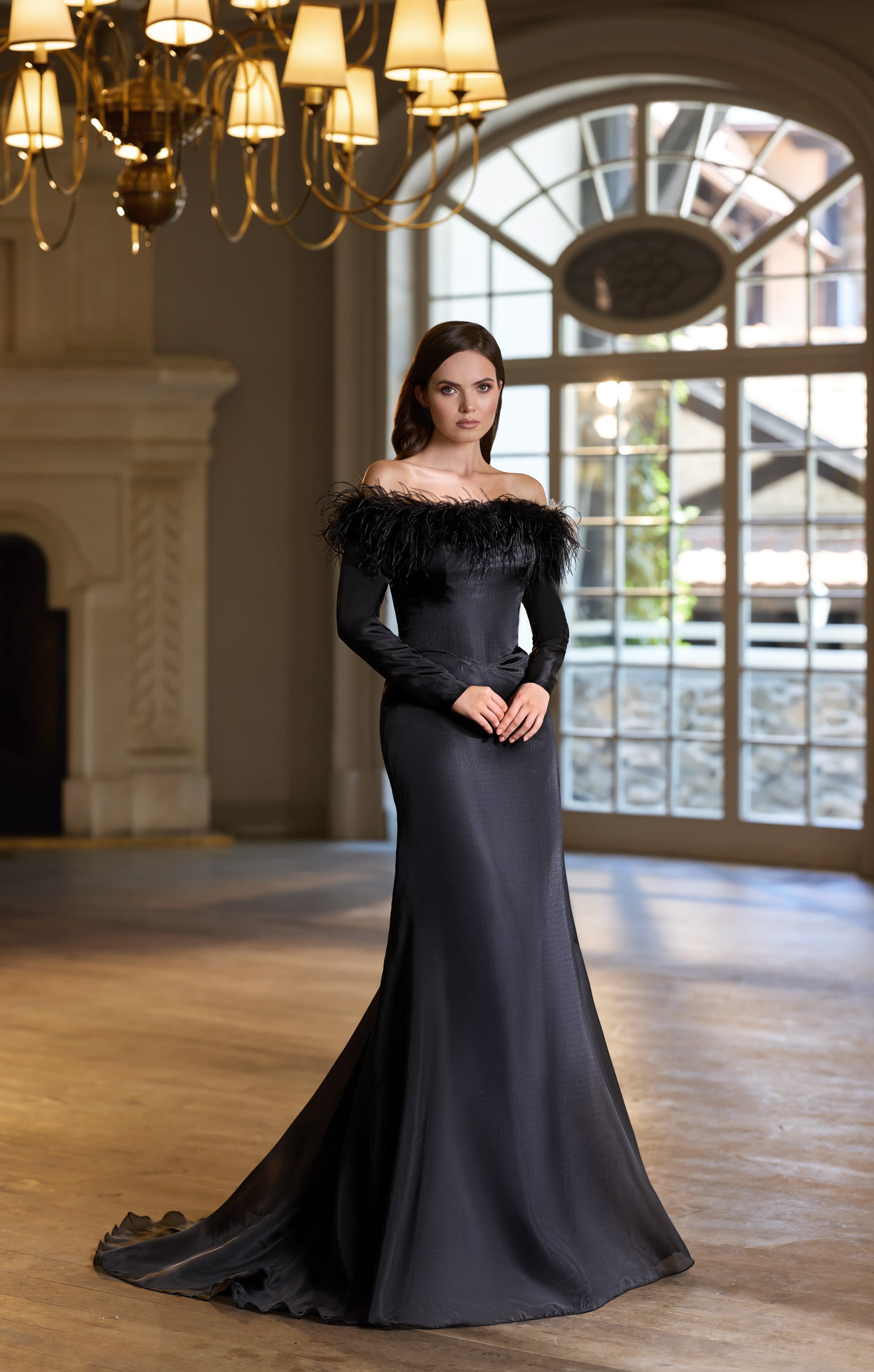 Black mermaid evening dress with an off-the-shoulder feathered neckline and dramatic train