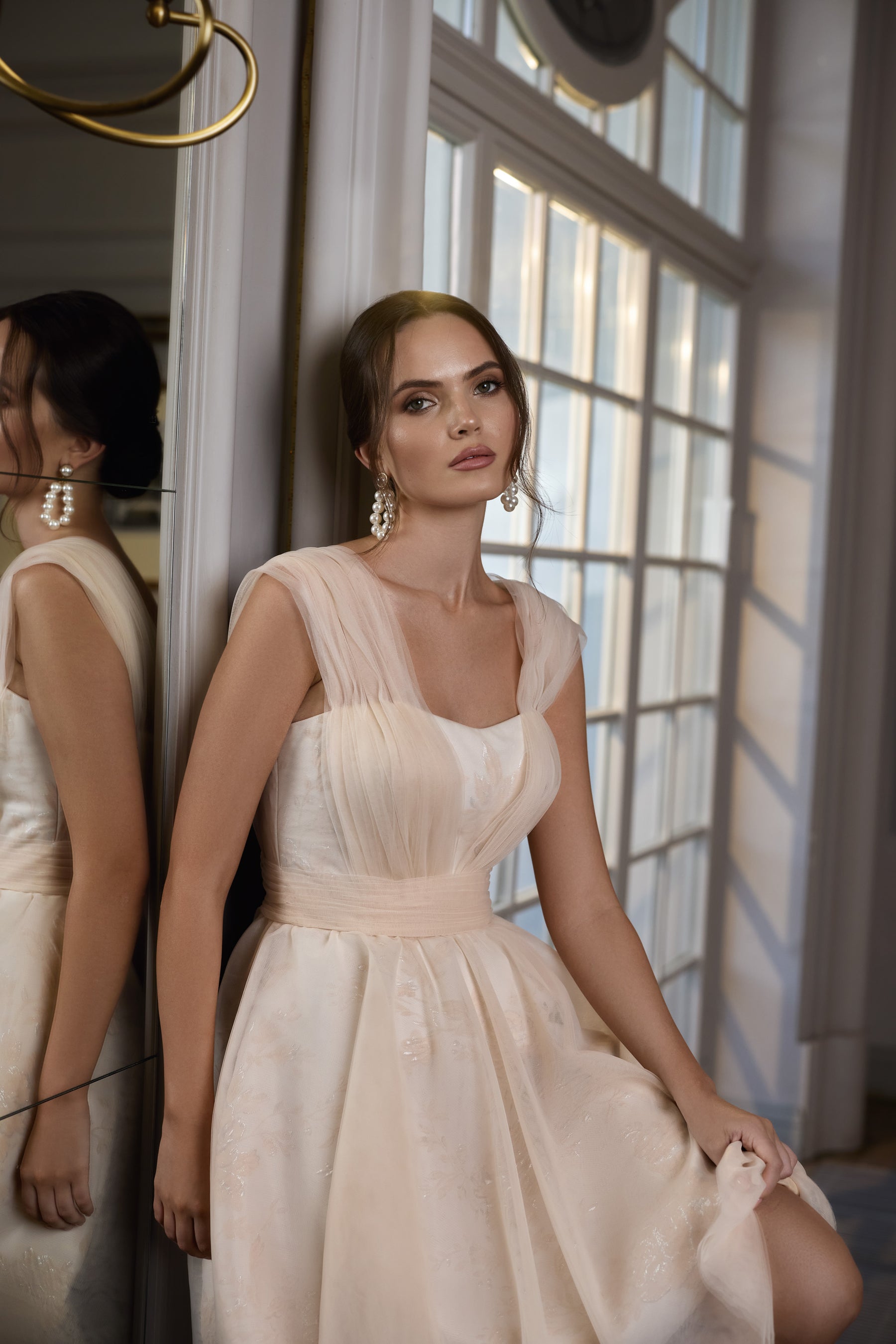 Ivory evening dress with a square neckline, sheer cap sleeves, fitted waist, and full skirt