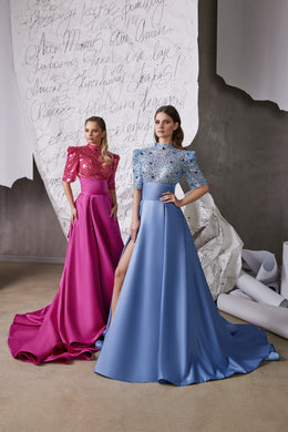 Blue glitter evening dress with a high neckline, three-quarter sleeves, thigh-high slit, and flowing A-line skirt