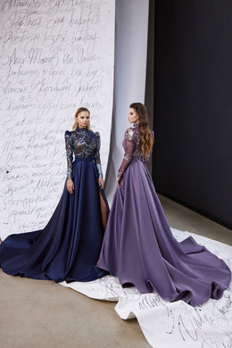 Navy and mauve evening dresses with embellished sheer long sleeves, flowing satin skirts, and high slits