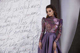 Mauve evening dress with a sparkling sheer bodice, long sleeves, belted waist, and front slit