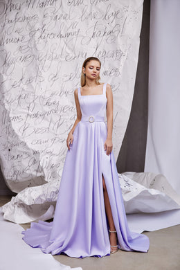 Full-length lavender evening dress with square neckline, thin straps, circular waist buckle, slit, and train