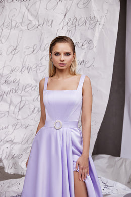Close-up of a lavender satin evening dress with square neckline, circular buckle, and high side slit