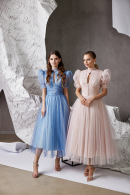 Blue and blush glitter tulle evening dresses with puff sleeves, fitted bodices, and tea-length skirts