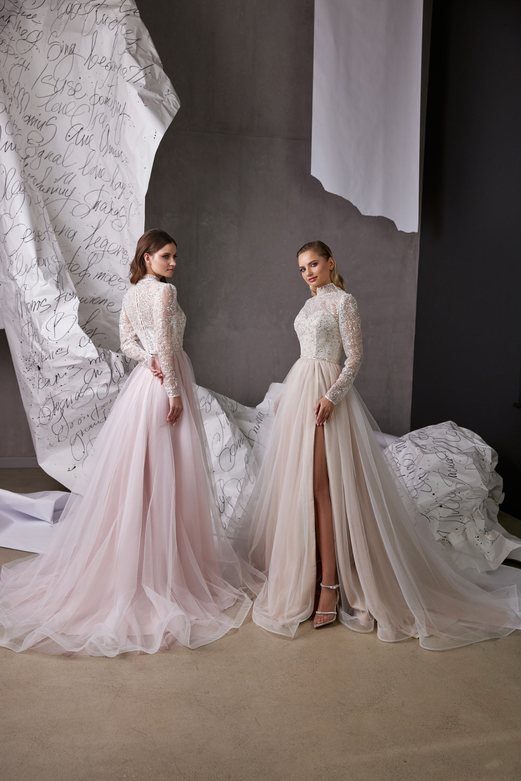 Pale pink and ivory evening dresses with beaded long sleeves, high necklines, flowing tulle skirts, and a high front slit