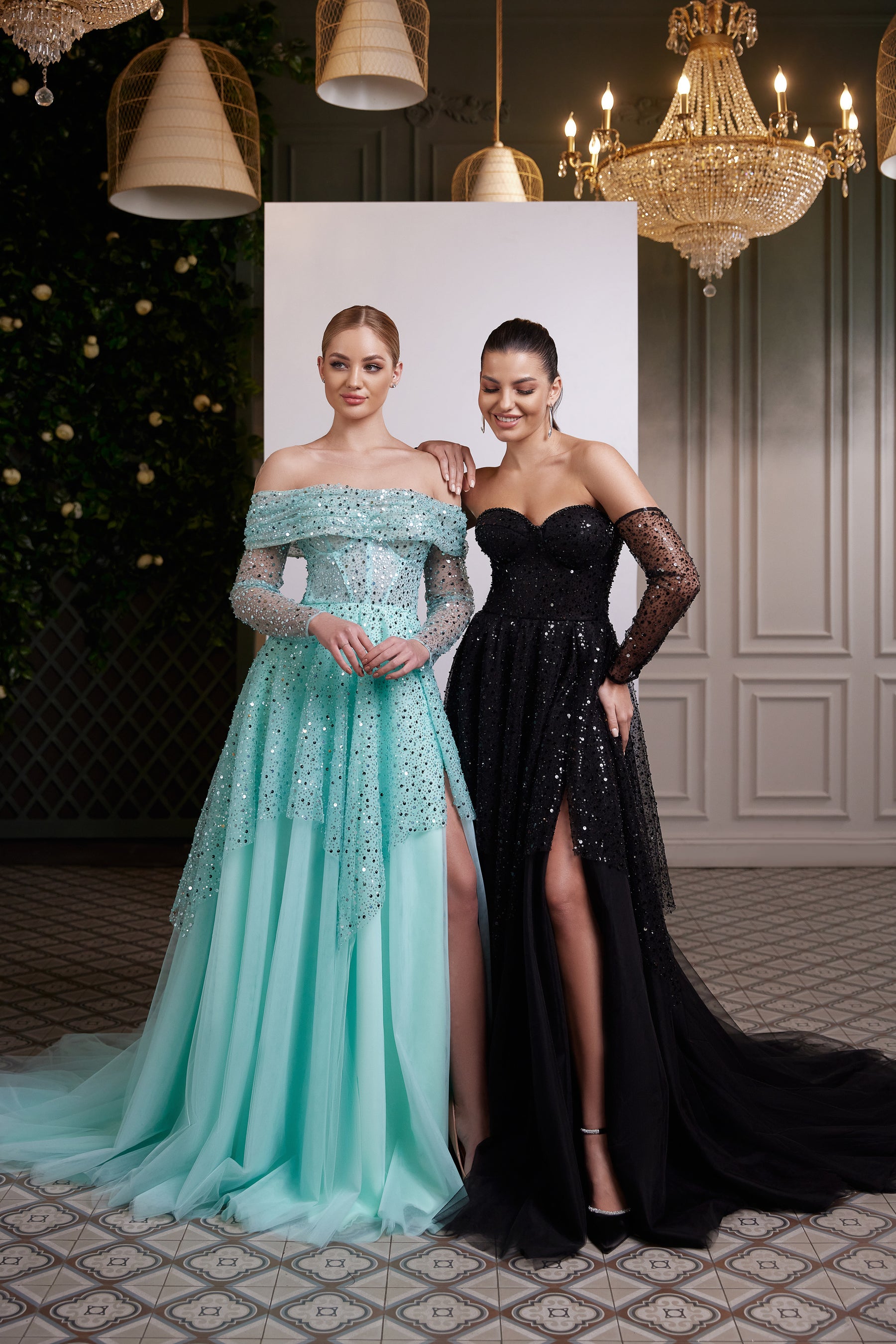 Black off-the-shoulder evening dress with sequins, sheer sleeves, fitted bodice, and thigh-high slit