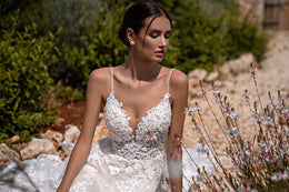 Elegant Guipure Wedding Dress with Crystals, Removable Ruffled Bolero, and Semi-Sheer Corset with Deep Cut