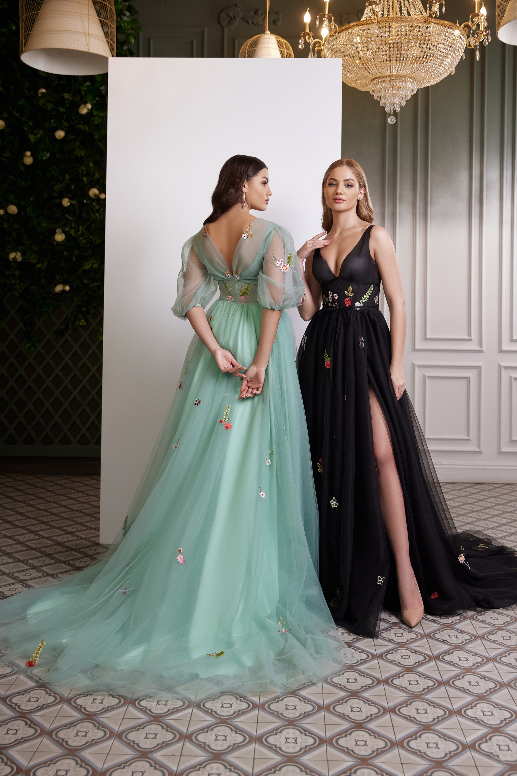 Mint green evening dress showing a low V-back, sheer puff sleeves, floral embroidery, and long train