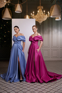 Blue and magenta satin evening dresses with off-shoulder draped necklines, thigh-high slits, and long trains