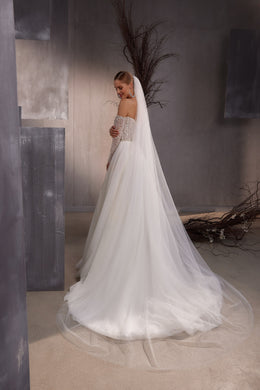Long sheer white wedding veil with subtle sparkle flowing from the head and pooling on the floor