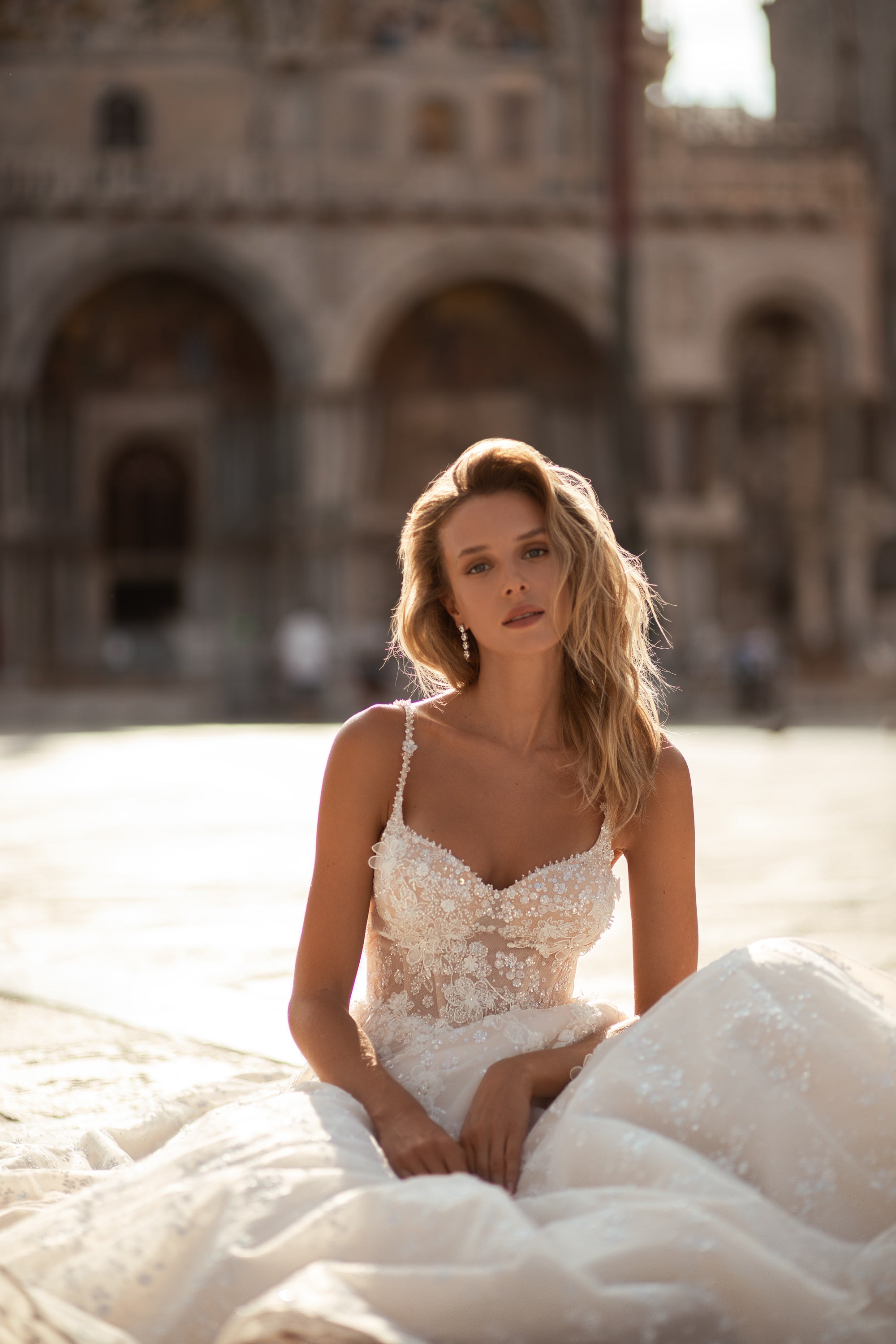Close-up of the sweetheart neckline and embellished floral lace bodice on an ivory wedding dress