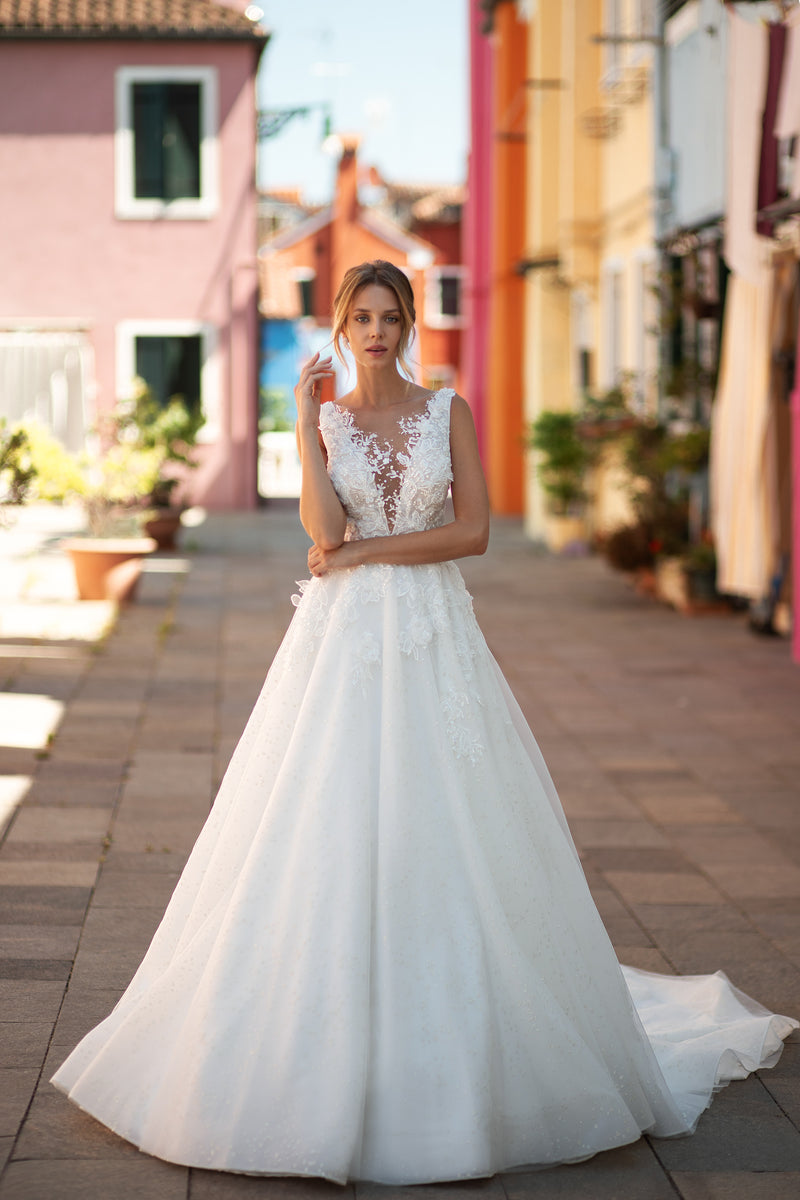 Ivory A-line wedding dress with an illusion V-neckline, sleeveless lace bodice, and sweeping train