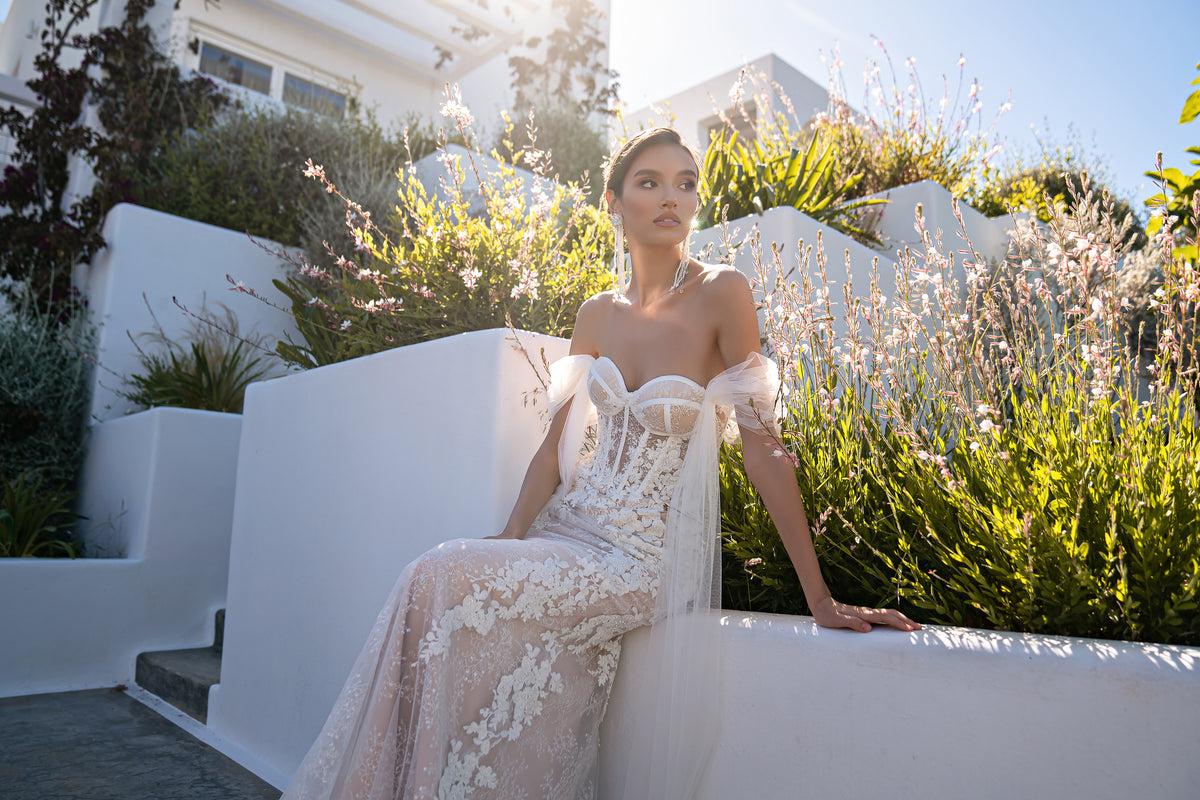 Floral lace wedding dress with a sweetheart neckline, sheer off-shoulder sleeves, and fitted mermaid silhouette