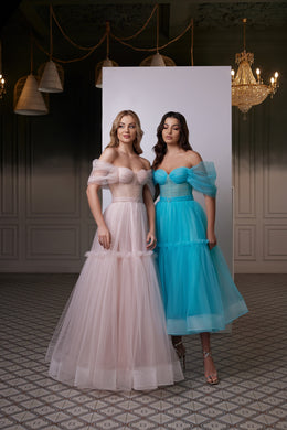 Blush pink evening dress with an off-the-shoulder sweetheart neckline, sheer sleeves, and layered tulle skirt