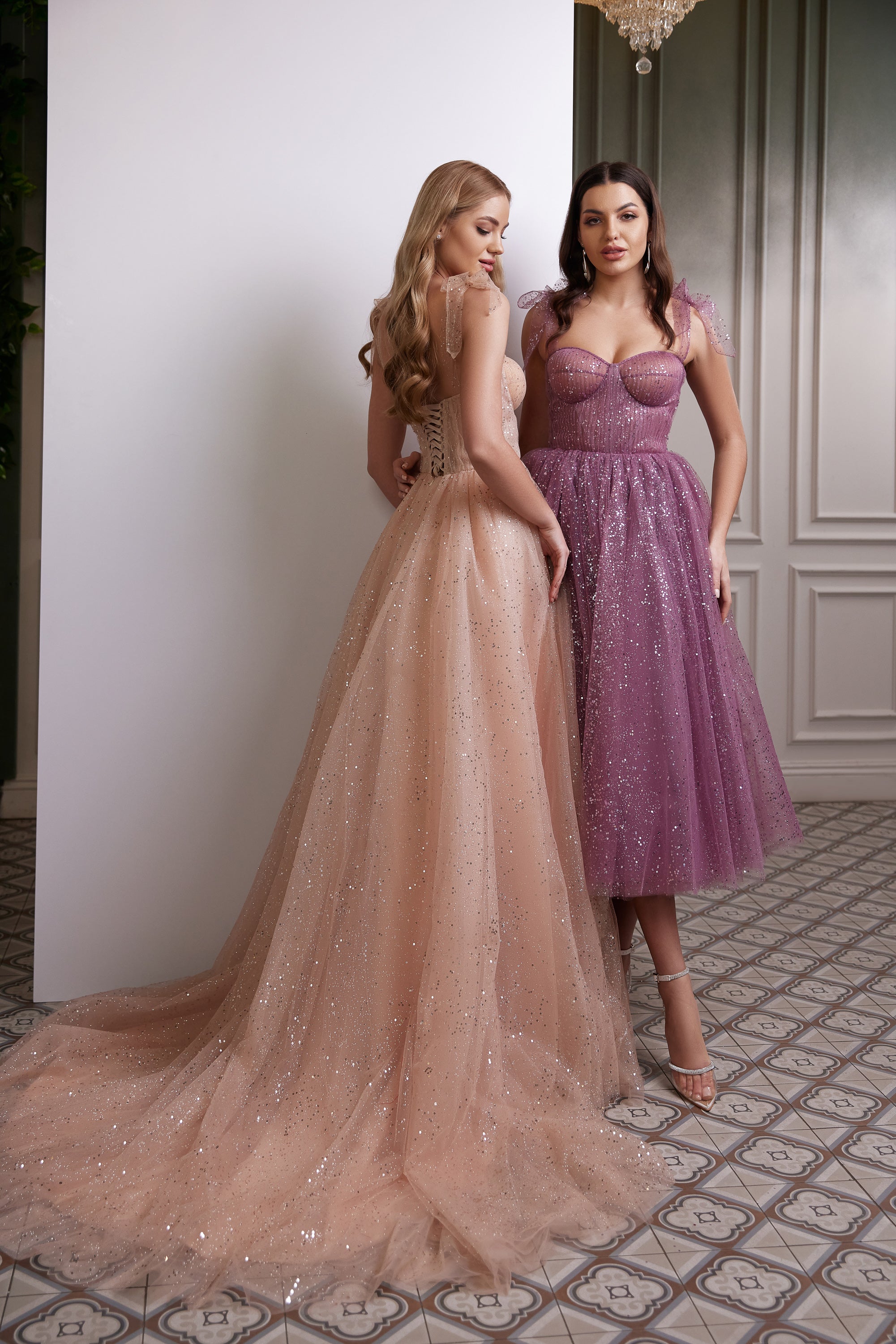 Purple sequined evening dress with sheer ruffled straps and a sparkling tea-length skirt, shown at a three-quarter angle
