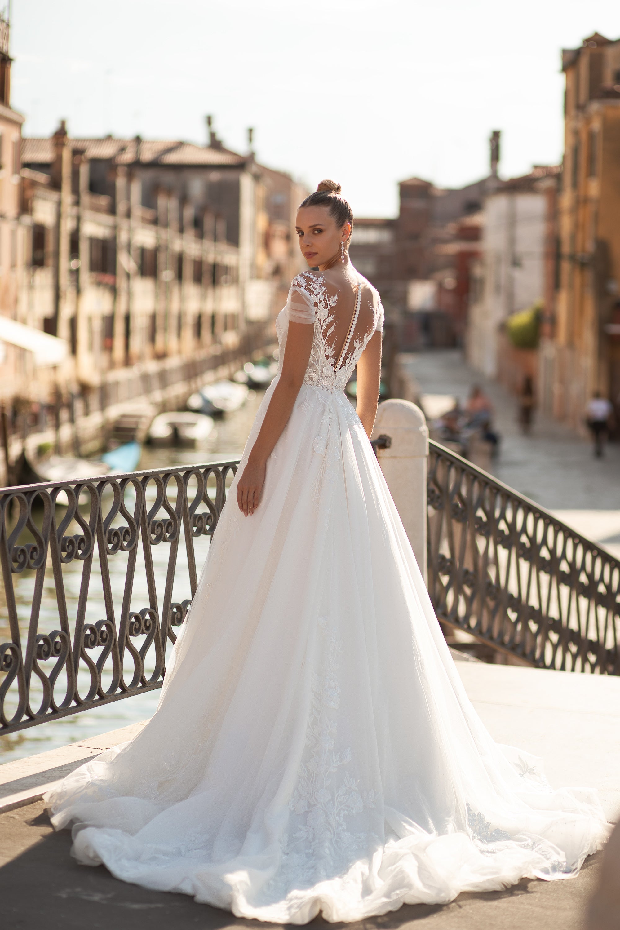 A-Line Bridal Dress with Tulle Fabric, Small Train, Lace Back with Buttons, Short Sleeves, and Flower Lace