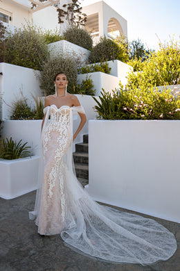 Ivory mermaid wedding dress featuring floral lace, off-shoulder tulle sleeves, and an extended train
