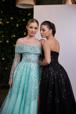 Back-facing black sequin evening dress with a strapless bodice, fitted waist, and full floor-length skirt