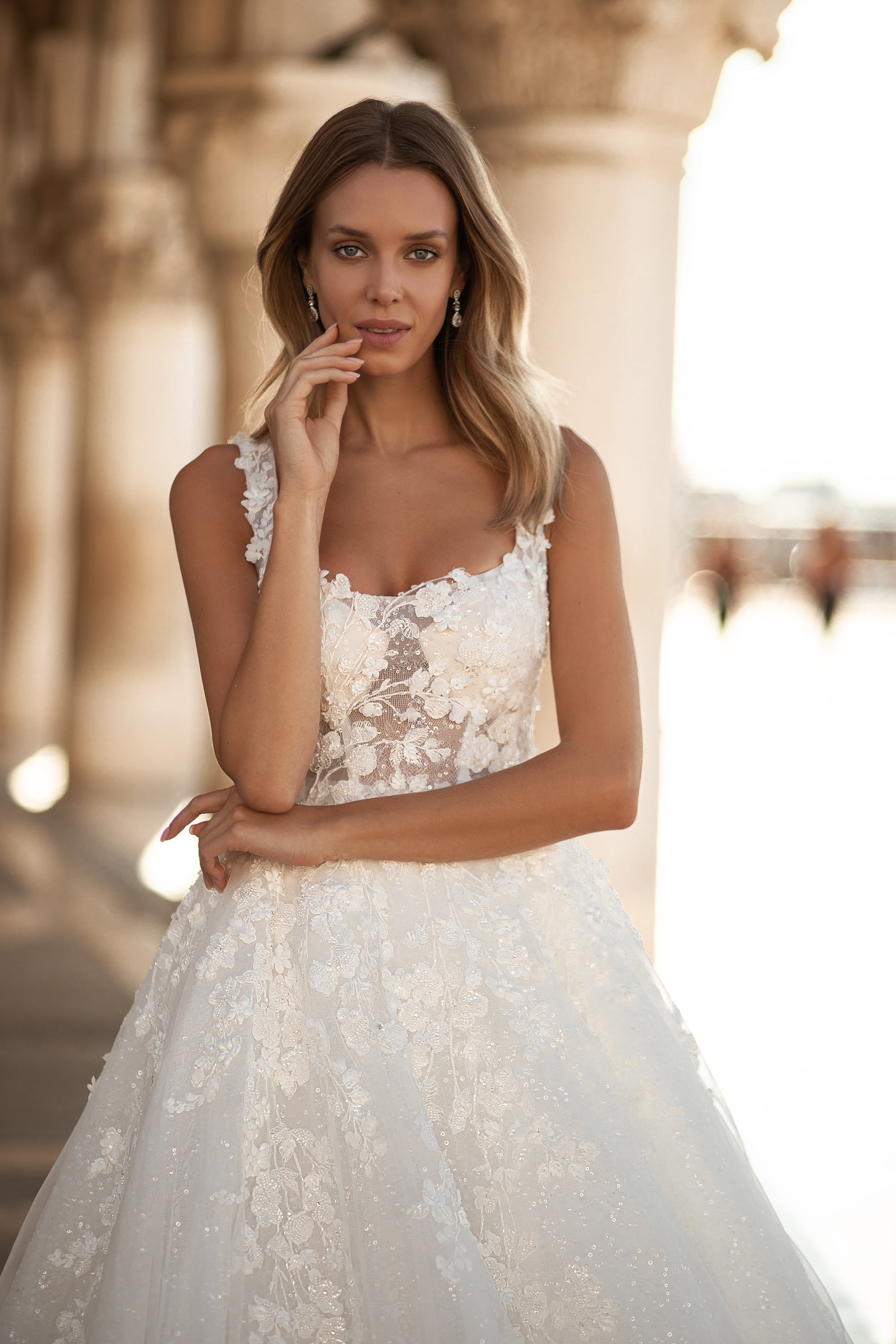 Close-up of the square neckline and floral lace bodice on an ivory A-line wedding dress