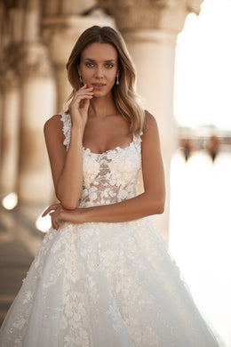 Close-up of the square neckline and floral lace bodice on an ivory A-line wedding dress