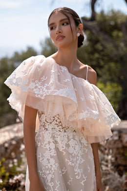 Elegant Guipure Wedding Dress with Crystals, Removable Ruffled Bolero, and Semi-Sheer Corset with Deep Cut