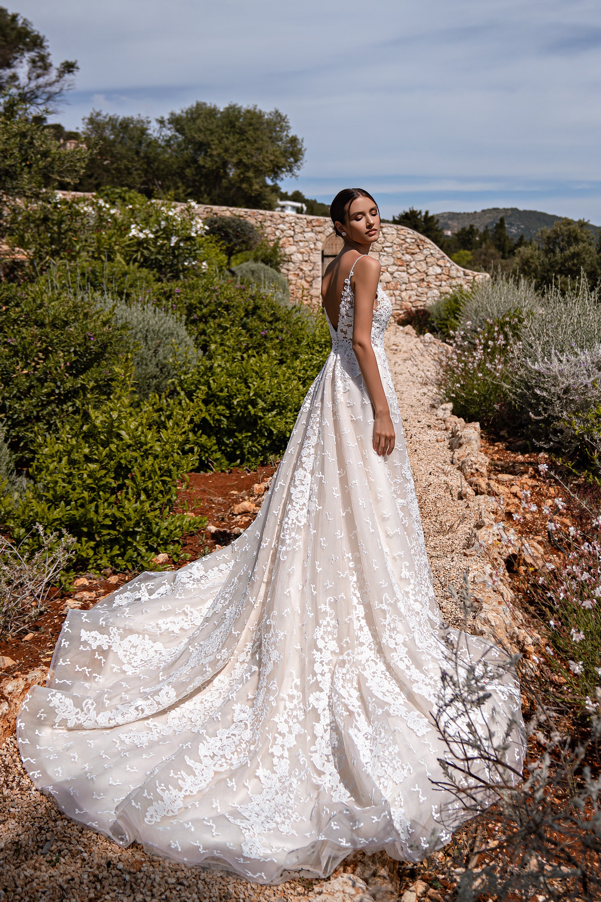 Elegant Guipure Wedding Dress with Crystals, Removable Ruffled Bolero, and Semi-Sheer Corset with Deep Cut