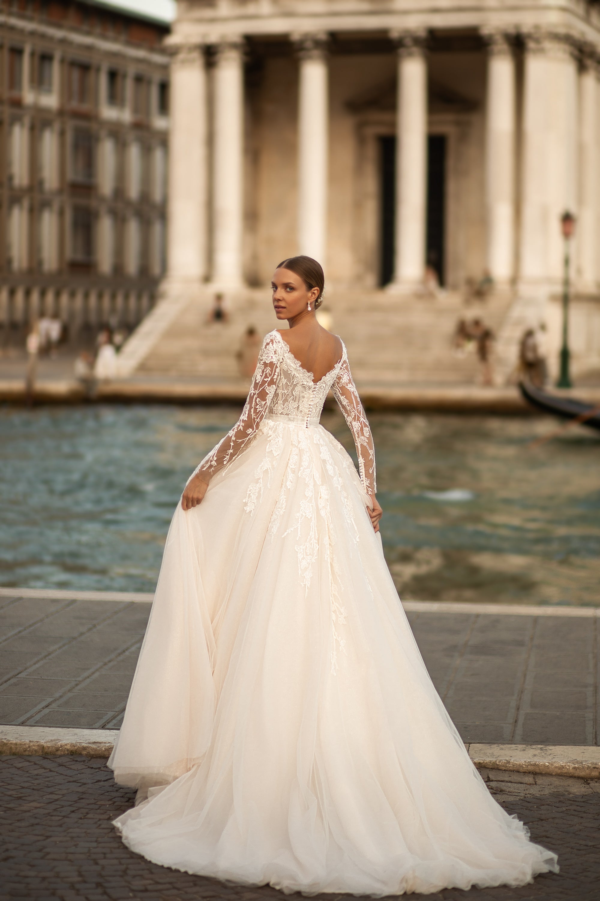 Elegant A-Line Wedding Gown with Tulle Skirt, Small Bow at Waist, Long Sleeves with Lace, Buttons Back, and Court Train